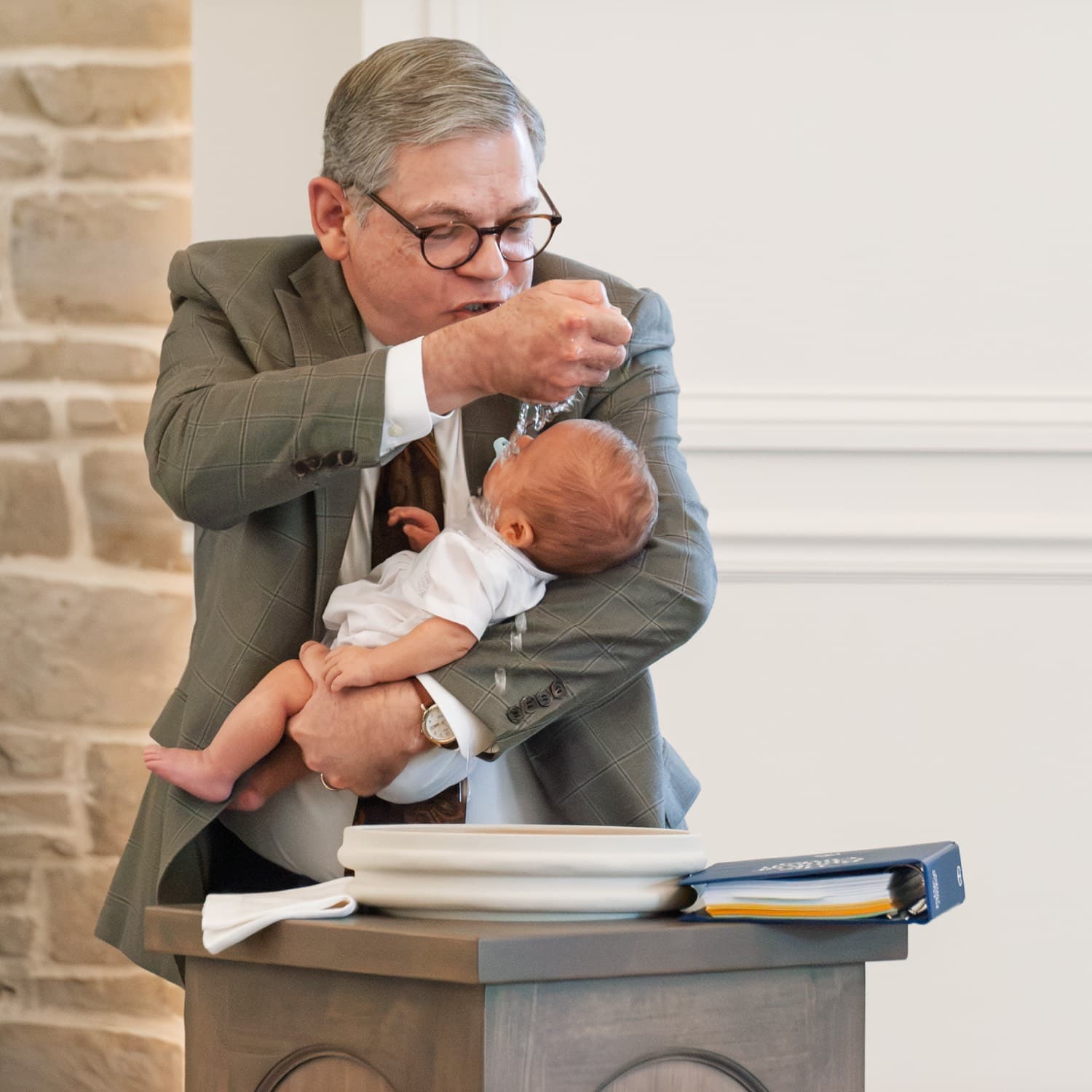 Pastor Rhett Dodson baptizes an infant during a Sunday service at Grace Presbyterian.