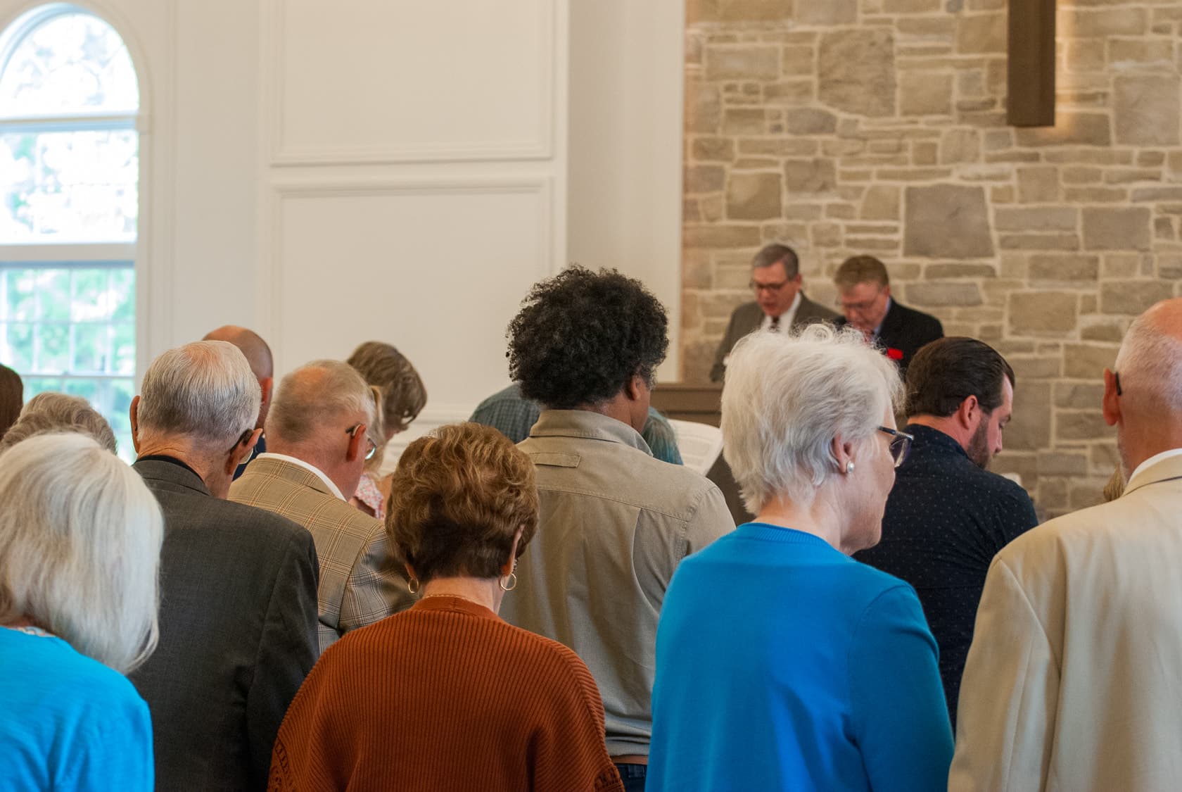 The congregation of Grace Presbyterian standing together in worship on a Sunday morning.