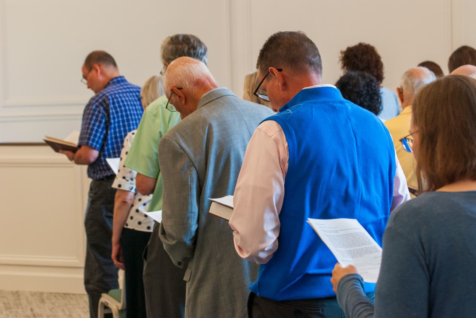 The congregation of Grace Presbyterian standing together in worship, hymnals in hand.